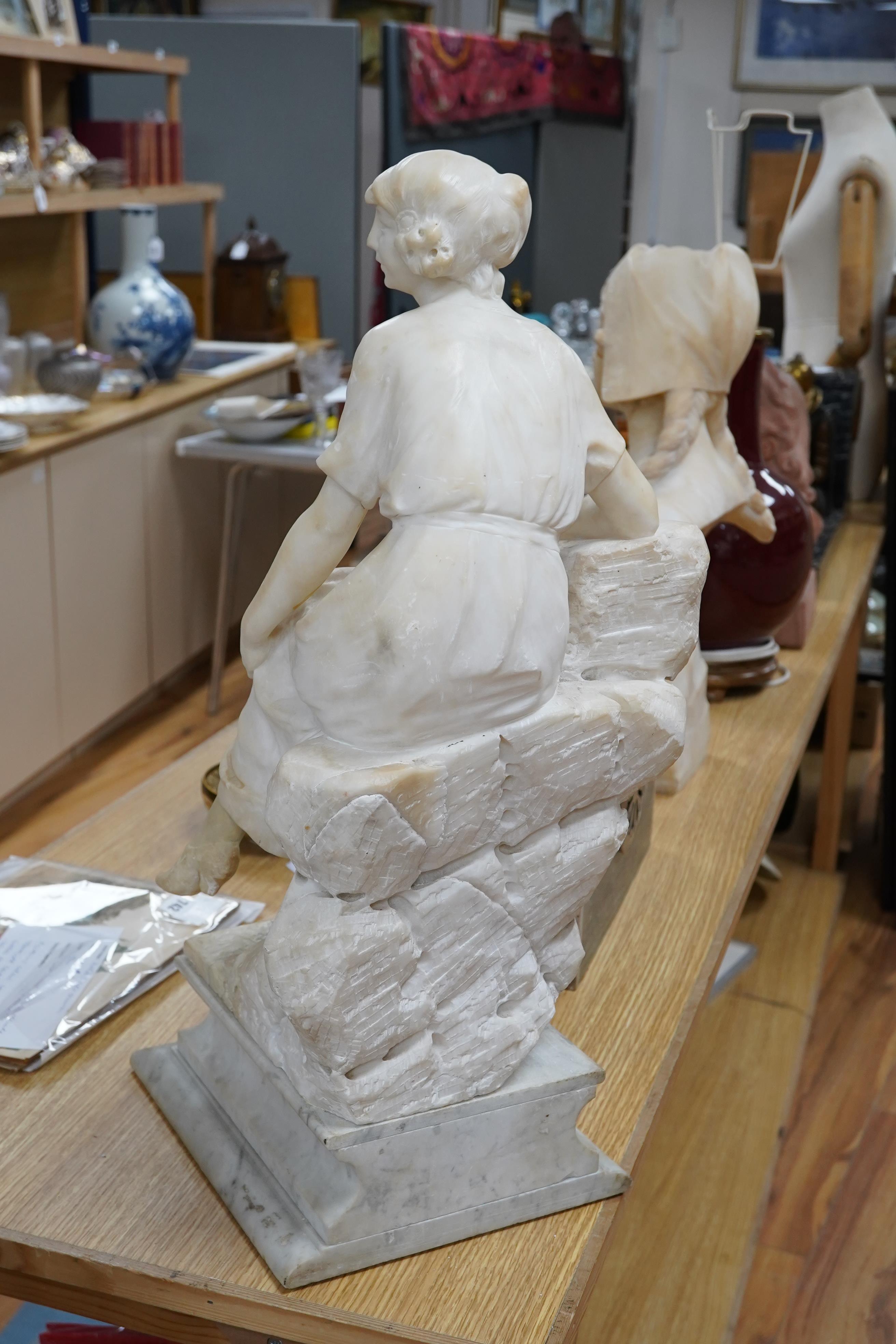 A French 1920’s-30’s alabaster sculpture of a lady seated on a stone wall, sculpture mounted on a marble stand, 63cm high. Condition - crack to alabaster at the front and discoloured restoration